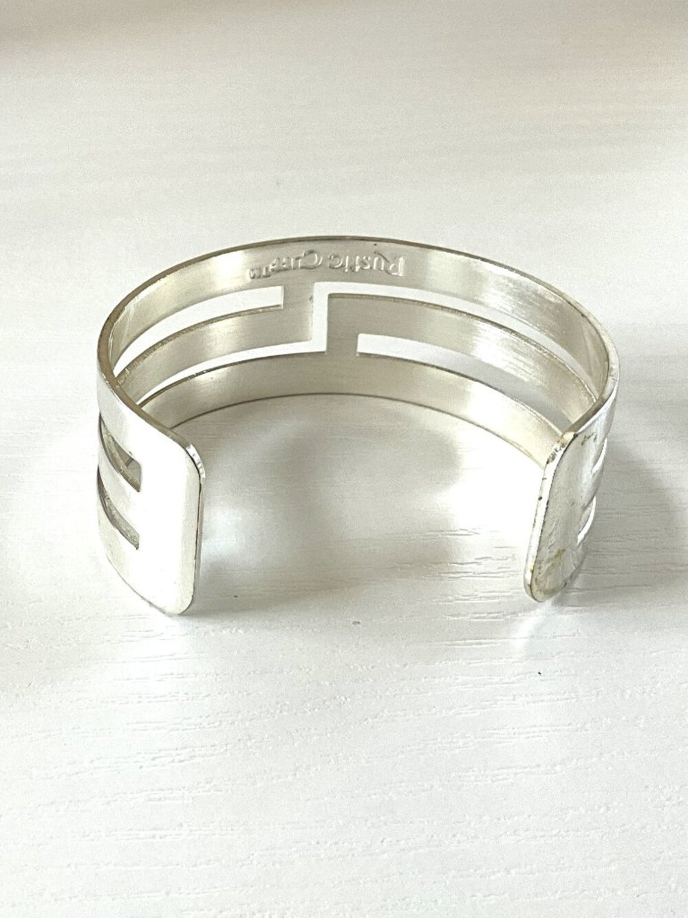 Rustic Cuff Silvertone Geometric Adjustable Logo Bracelet - Picture 2 of 2